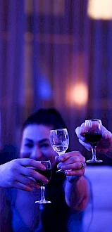 A group toasting with champagne in a dim, colorful party setting. Top it at 140 characters, always ending the sentence.